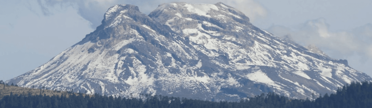 A distant mountain range with snow on it.