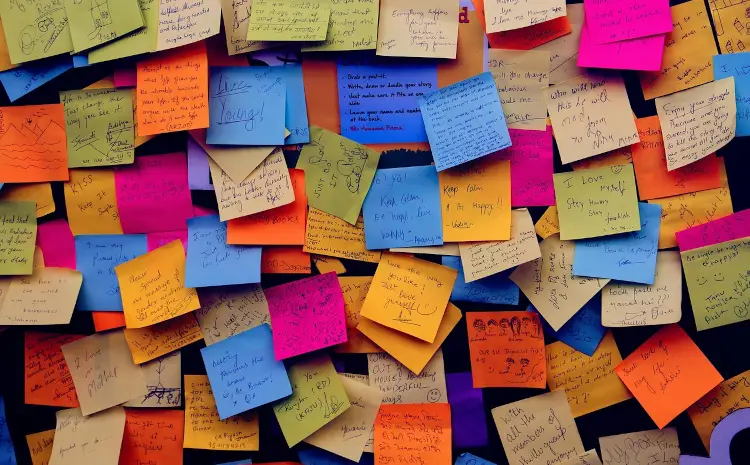A colorful collection of post-it-notes with affirmations written on them.