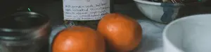 AI image of two oranges, a white ceramic dish with a bottle of tincture in the background.